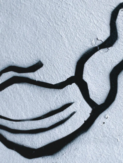 Graffiti with facial mask on the wall during the current Coronavirus (COVID-19) pandemic in Warsaw, Poland